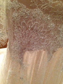 Detail of white lace dress by Paul Vasileff and Paolo Sebastian
